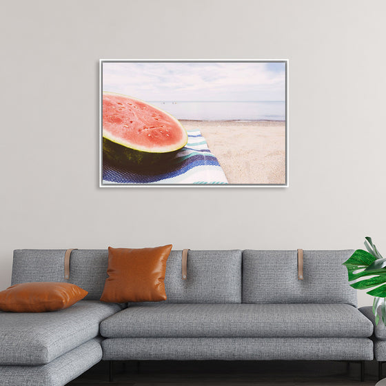 "Half of a watermelon on the beach"