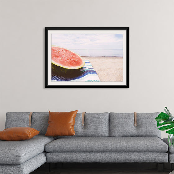 "Half of a watermelon on the beach"