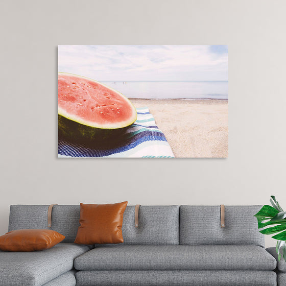 "Half of a watermelon on the beach"