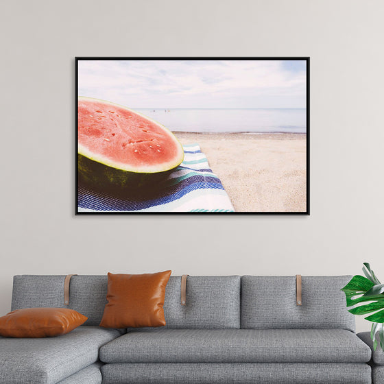 "Half of a watermelon on the beach"