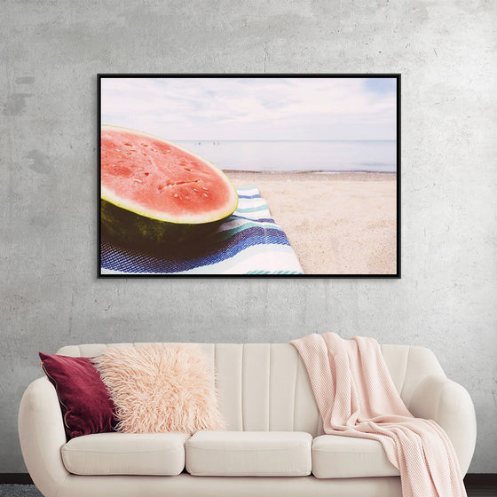 "Half of a watermelon on the beach"