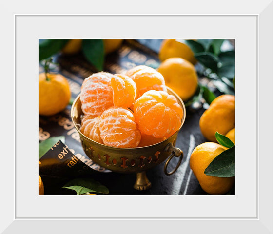 "Oranges in a bowl peeled"