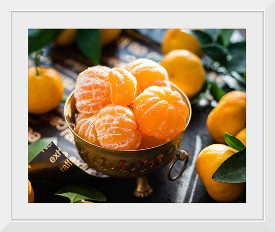 "Oranges in a bowl peeled"