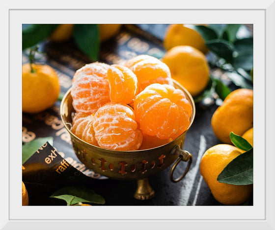 "Oranges in a bowl peeled"