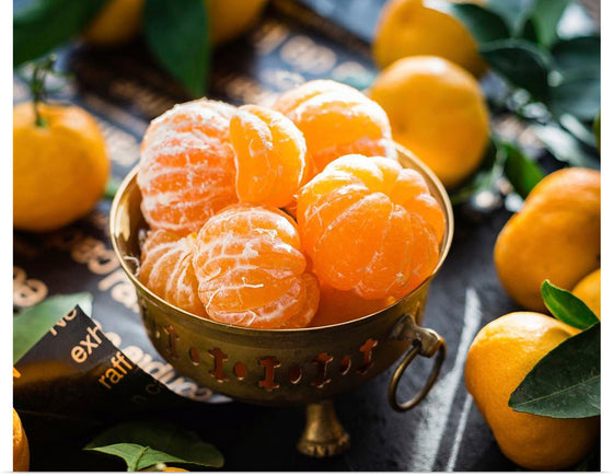 "Oranges in a bowl peeled"