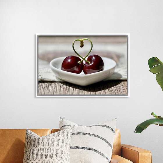 "Pair of cherries in small bowl"