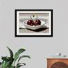 "Pair of cherries in small bowl"