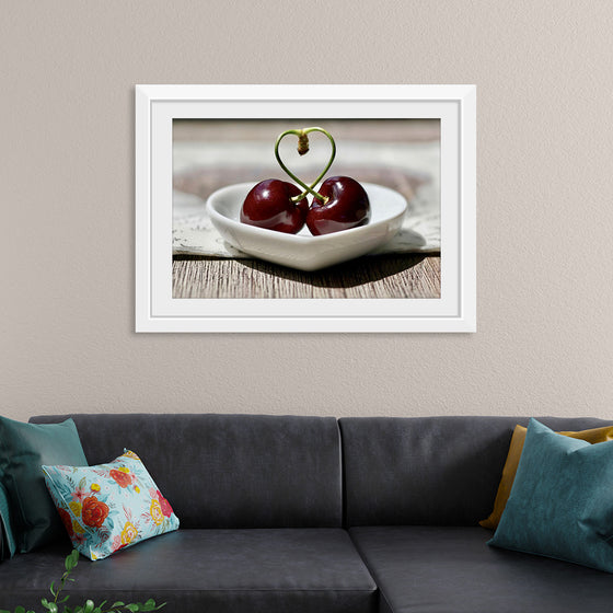 "Pair of cherries in small bowl"