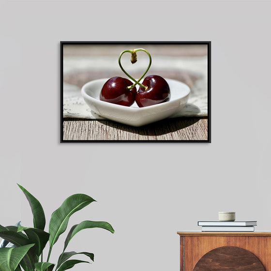 "Pair of cherries in small bowl"