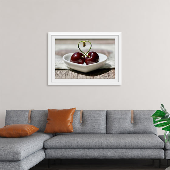 "Pair of cherries in small bowl"