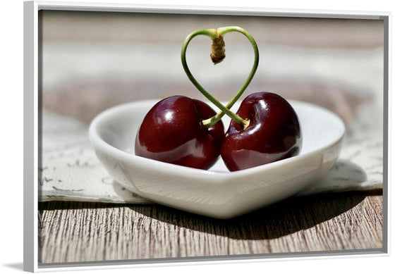 "Pair of cherries in small bowl"