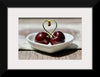 "Pair of cherries in small bowl"