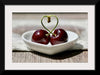 "Pair of cherries in small bowl"