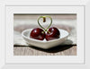 "Pair of cherries in small bowl"