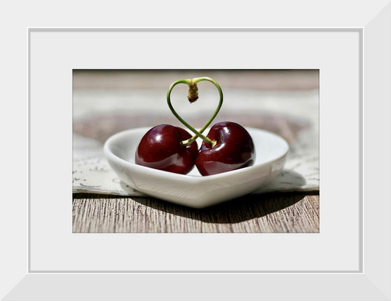 "Pair of cherries in small bowl"