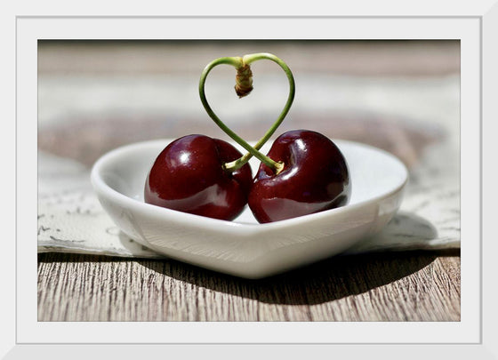 "Pair of cherries in small bowl"