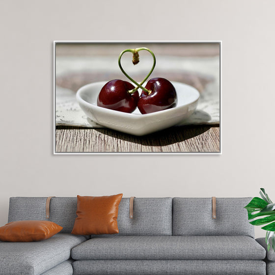 "Pair of cherries in small bowl"