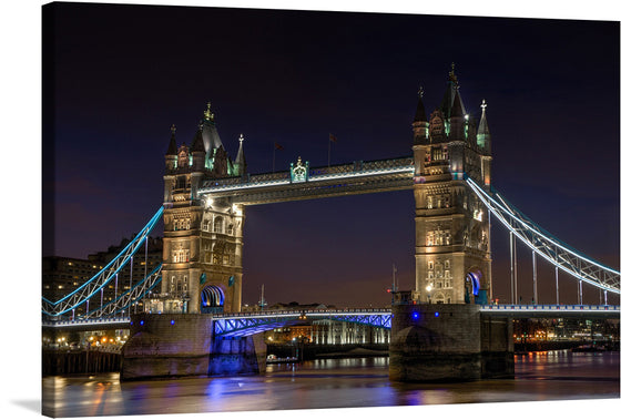 Illuminate your space with the mesmerizing glow of London’s iconic Tower Bridge at night. This exquisite print captures the architectural marvel adorned with radiant lights, reflecting a symphony of colors upon the tranquil waters of the River Thames. Every detail, from the majestic towers to the intricate suspension cables, is captured with pristine clarity - inviting viewers into a serene yet vibrant London nightscape. 