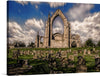 “Bolton Abbey In North Yorkshire” is a captivating piece of art that encapsulates the timeless elegance of this iconic structure amidst a tranquil graveyard. Each print delivers an exquisite play of light and shadow, illuminating the abbey’s majestic arches against a backdrop of dramatic skies. 