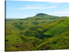 This exquisite landscape print captures the serene beauty of lush green rolling hills under a clear blue sky. The gentle slopes and the majestic mountain peak are rendered with stunning clarity, bringing a piece of nature’s tranquility into your living space. It’s more than just a print; it’s an escape to a world where green horizons meet blue skies in perfect harmony. 