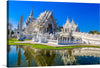“Wat Rong Khun,” also known as the White Temple, is a stunning and unique Buddhist temple located just 15 kilometers from the city of Chiang Rai in northeastern Thailand.