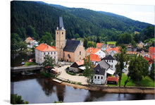  “Rozmberk, Czech Republic” is a captivating print that transports you to a peaceful European village nestled amidst lush greenery. The artwork captures the charming scene of colorful houses, a historic church with an elegant steeple, and the tranquil river that flows gracefully through the town. 