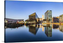  Immerse yourself in the serene beauty of the “Liverpool, UK Waterfront” print. This exquisite piece captures the iconic waterfront with its modern architecture and historic charm, bathed in the golden embrace of the setting sun. The calm waters mirror the skyline, creating a symphony of light and structure that brings life and energy to any space. 