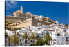 This exquisite print captures the enchanting allure of a serene Mediterranean town. The iconic white-washed architecture, nestled against a backdrop of azure skies, epitomizes timeless elegance. The intricate detailing of ancient stone walls and charming buildings invites you to wander through narrow alleys, past rows of swaying palm trees, and ascend the historic hilltop fortress. 