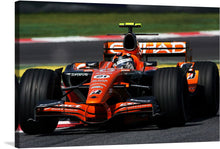  Capture the heart-pounding adrenaline of Formula 1 racing with this electrifying print. The sleek orange race car, a screams across the empty track, its every curve and aerodynamic detail rendered in a stunning photo. The driver, his face a blur of focus behind his visor, stares down the course, his determination palpable.