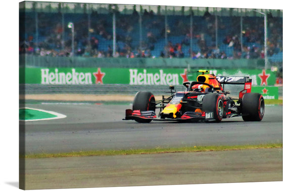 Capture the exhilarating speed and precision of Formula 1 racing with this stunning print! Every detail, from the sleek design of the race car adorned in vibrant colors to the blurred background capturing its rapid motion, brings the thrill of the race into your space. The distant spectators and prominent Heineken® advertisements immerse you in a world where engineering and adrenaline coalesce. 