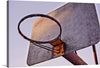 Capture the essence of the game with this striking print featuring an up-close view of a weathered basketball hoop against a soft, muted sky. The rich textures and subtle hues of rust and wear tell a story of countless games, victories, and defeats. Every mark and imperfection adds character, making it not just a piece of art but a slice of history.