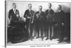 “Original Dixieland Jazz Band from Talking Machine World, January 15, 1921” is a black and white photograph featuring five members of the Original Dixieland Jazz Band. Each member is holding a different musical instrument including drums, trombone, clarinet, trumpet, and saxophone.