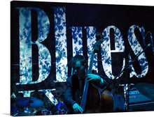  Immerse yourself in the soul-stirring world of blues with this captivating print. The artwork captures a musician, lost in the emotive dance of playing a double bass, against the backdrop of a word that encapsulates the essence of his art - “BLUES”. The dark, moody tones are punctuated by splashes of light that dance as wildly as the notes being played.