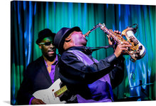  Immerse yourself in the captivating world of jazz with this stunning photograph. Depicting two talented musicians, the image showcases the passion and skill involved in playing the saxophone. As their fingers dance across the keys, the soulful melodies fill the air, transporting you to a realm of musical enchantment.