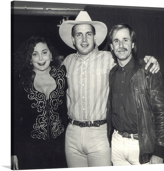 Garth Brooks, Jennie Frankel, and John Ford Coley are captured in this iconic photograph at the Country Music Awards.