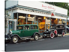  This print features a charming scene of two vintage cars parked in front of a seafood restaurant. The cars are in excellent condition and the restaurant has a welcoming atmosphere. This print would make a great addition to any home or office.