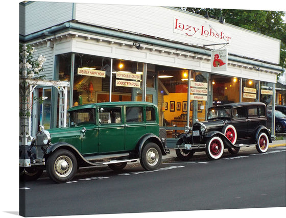 This print features a charming scene of two vintage cars parked in front of a seafood restaurant. The cars are in excellent condition and the restaurant has a welcoming atmosphere. This print would make a great addition to any home or office.