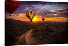  This captivating print captures the enchantment of a sunrise hot air balloon ride. The vibrant balloons, painted in hues of red, orange, and rainbow stripes, ascend gracefully against the warm backdrop of the rising sun.