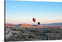  Elevate your space with this mesmerizing print capturing the serene beauty of a golden landscape, adorned by the graceful dance of hot air balloons in the sky. As the sun kisses the earth, illuminating intricate formations and casting enchanting shadows, experience a moment of tranquility and wanderlust.