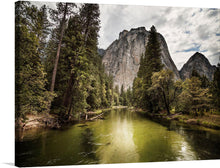  This artwork, titled “Yosemite National Park, United States,” captures the serene beauty of Yosemite National Park. The print features a calm river flowing through the heart of the park, surrounded by lush greenery and towering granite cliffs. The partly cloudy sky casts dynamic shadows across the landscape, while the river reflects the sky and cliffs, creating an ethereal effect.