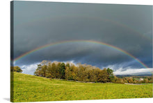  This beautiful photograph of a double rainbow in the sky over a green field is a must-have for any nature lover or fan of fine art. The artwork is also notable for its composition. The double rainbow is centered in the frame, and the green field is positioned below it.