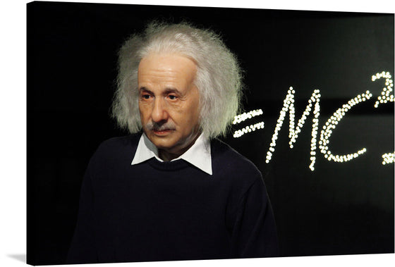 This is a beautiful photograph of a wax figure of Albert Einstein. The figure is standing in front of a lighted equation, E=mc2, which is a formula for the theory of relativity. The figure is made of wax and has a black background.