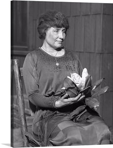  “Helen Keller” is a captivating artwork that encapsulates the essence of an iconic figure, immortalized in a moment of serene contemplation. The grayscale tones imbue the piece with a timeless elegance, while the intricate details of her attire and the delicate bloom she holds narrate a silent tale of grace and resilience. 