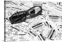  “Ticket Stubs and 3D Glasses” is a captivating ode to cinematic memories. In this monochromatic masterpiece, a scatter of iconic movie ticket stubs cradles a pair of elegant 3D glasses. Each ticket whispers tales of late-night escapades, heart-pounding blockbusters, and whispered secrets shared in dimly lit theaters. 