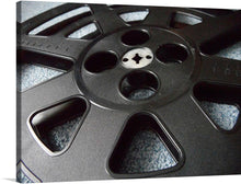  “Film Closeup” is a striking print that captures the essence of the film industry. The print features a closeup of a film reel, showcasing the intricate details of the reel and the texture of the film. This print would be perfect for any film enthusiast or anyone who appreciates the art of film making. Film reels were the primary means of capturing images before digital photography became popular. 