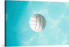 Dive into the serene beauty of “Volleyball,” a print capturing the tranquil moment a volleyball floats gracefully atop the gentle waves of a crystal-clear pool. The stark contrast between the ball’s structured design and the fluid dance of light and water creates a visual symphony, evoking feelings of summer bliss and peaceful solitude.