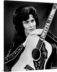  This stunning print captures the legendary Loretta Lynn, posing with her acoustic guitar in a captivatingly classic 1965 photo&nbsp;by Les Leverett. Lynn's confident expression and piercing gaze exude her signature strength and determination, while her acoustic guitar symbolizes her lifelong passion for music.