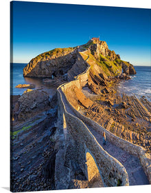  A Breathtaking Island on the Coast of Biscay. Imagine waking up to the sound of waves crashing against the shore, with a view of a breathtaking island just a short walk away. That's what you'll get with this stunning photo of Gaztelugatxe, a small islet on the coast of Biscay in Spain.
