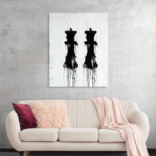  "2 Queens" by Kent Youngstrom is a striking black and white abstract artwork. The piece features two vertical figures that appear to be queens, with their heads and bodies made up of drips and splatters of black paint. The figures are set against a white background, creating a bold contrast. This artwork would make a great statement piece in any room.