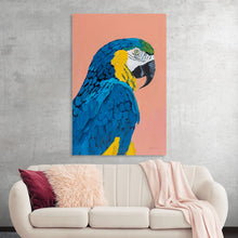  Immerse yourself in the vibrant and captivating allure of this exquisite parrot artwork. Every brushstroke on this print captures the majestic beauty of a parrot, with its rich blue and yellow feathers vividly contrasting against a soft coral backdrop. 